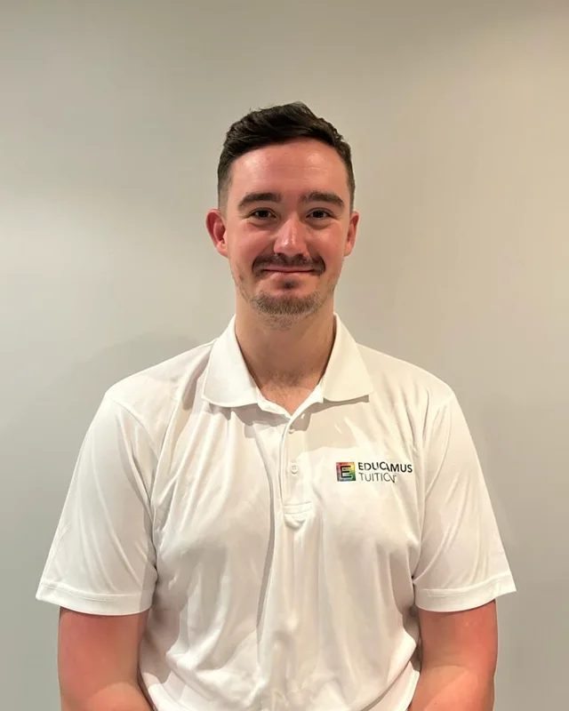 Adam, an Educamus Tuition maths and physics tutor, in a white Educamus Tuition polo shirt